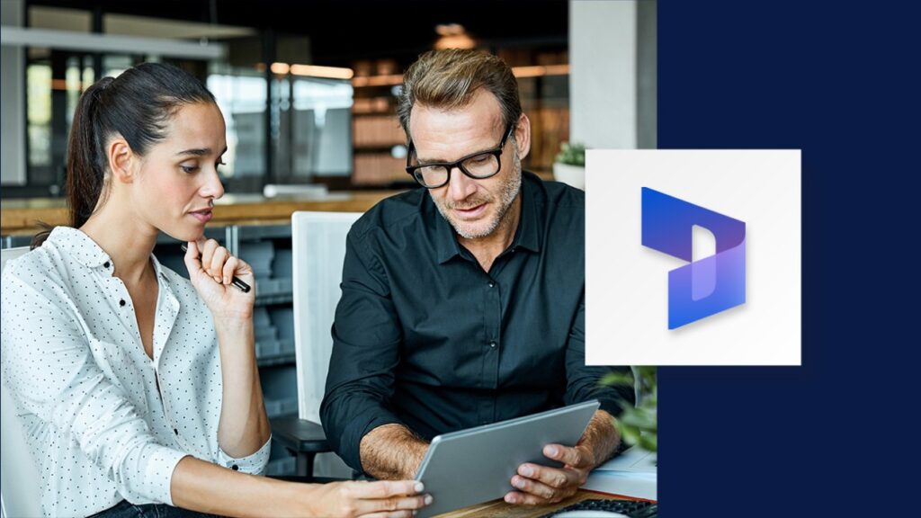 A man and woman sitting at a table, looking at a tablet. Navy blue borders the right side of the image, overlaid with the Dynamics 365 logo.